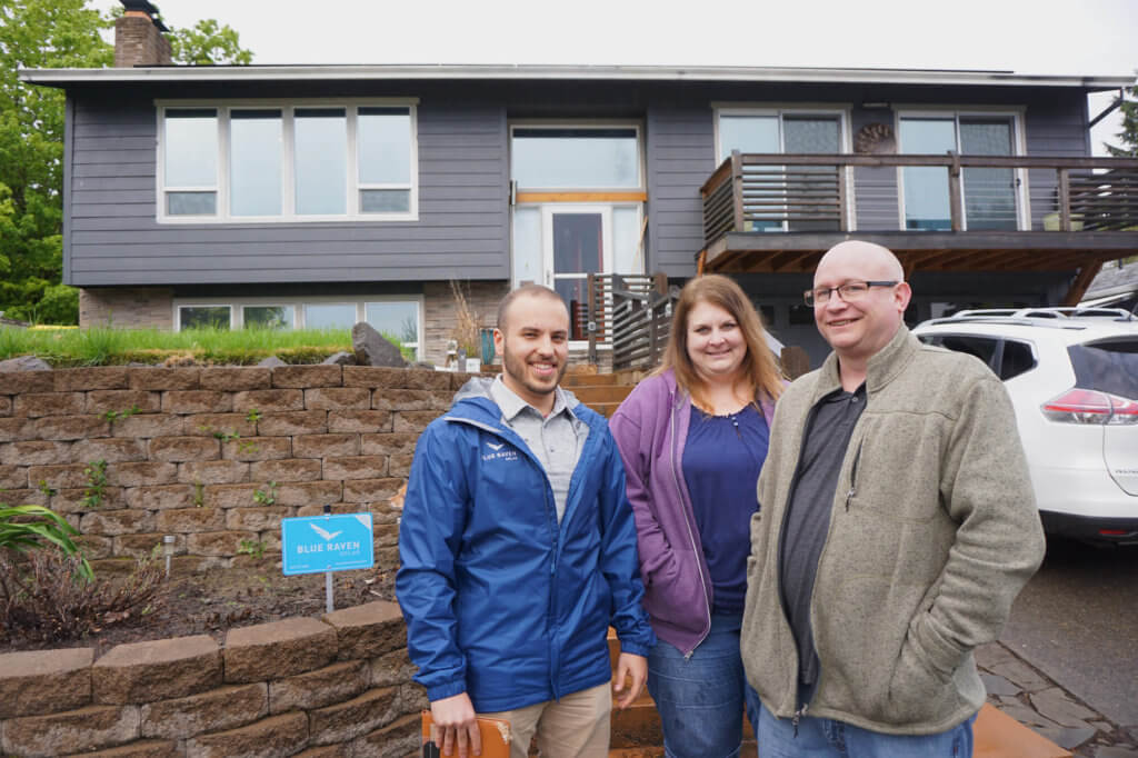 Blue Raven Solar sales representative, standing with happy customers in front of their home after a successful installation