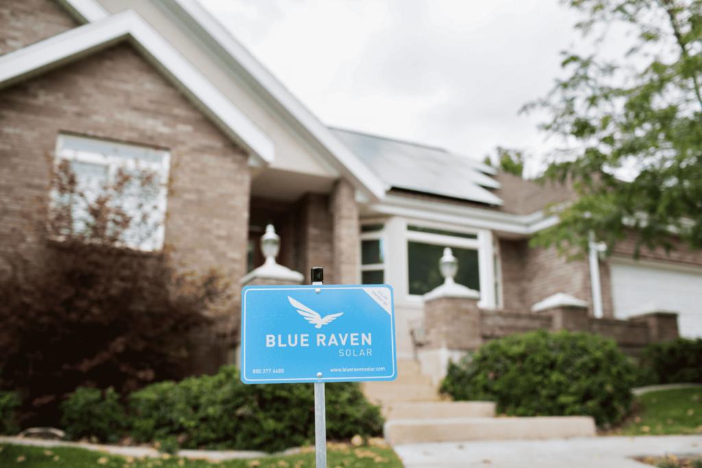 Blue Raven Solar sign in front of brick house