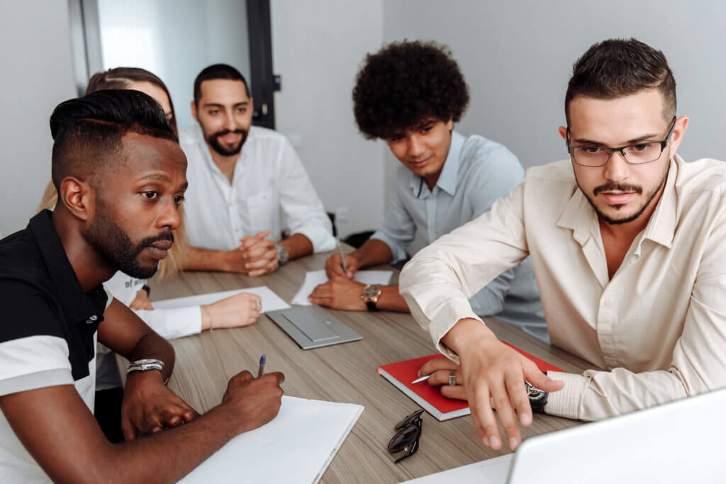 Team presentation or virtual meeting with indvidual contributors gathered around a singular table