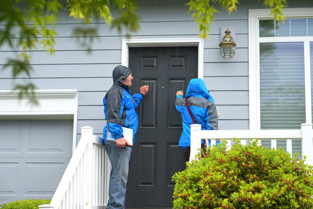 Blue raven workers knocking on door