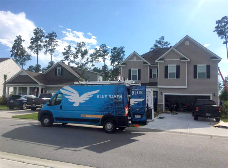 Blue Raven Solar Truck out in front of house installing solar panels