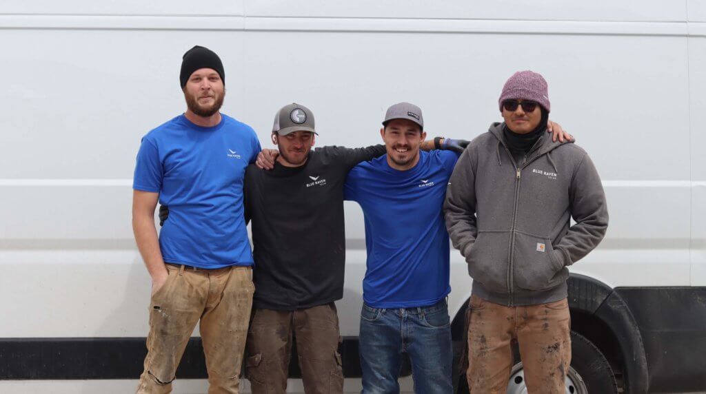 Utah based installation crew, four males standing in front of BRS van with arms around each other
