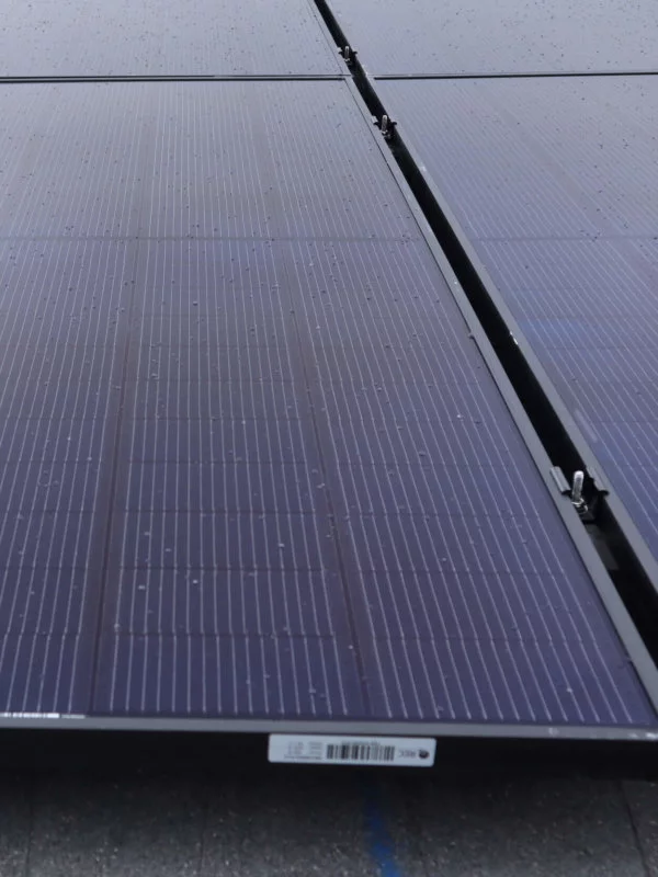 Up close view of solar panels installed on roof, in a grid