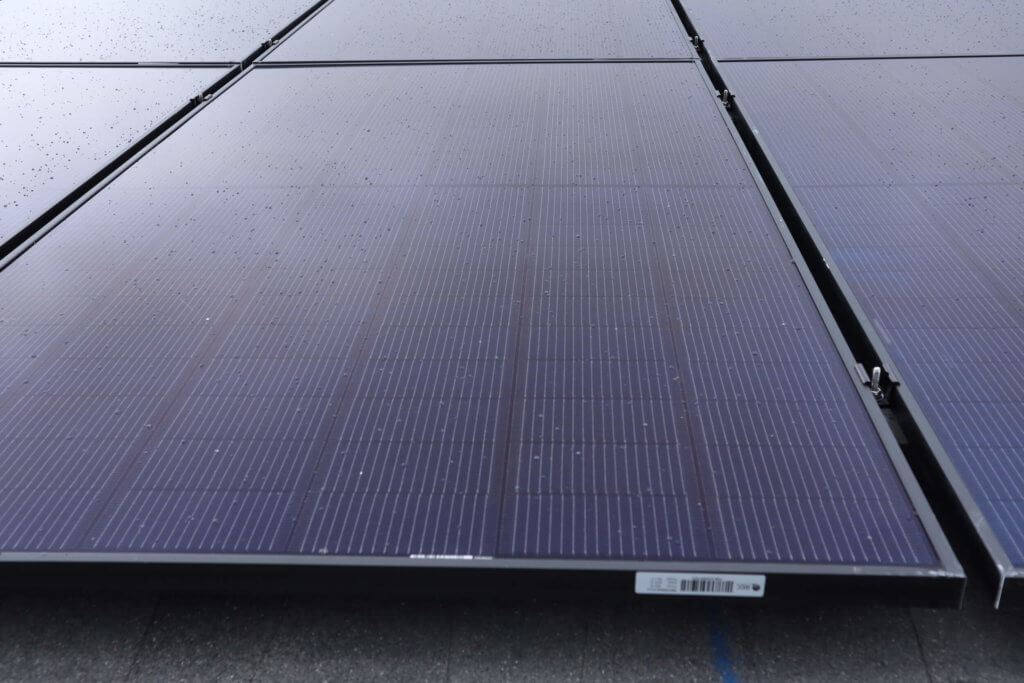 Up close view of solar panels installed on roof, in a grid