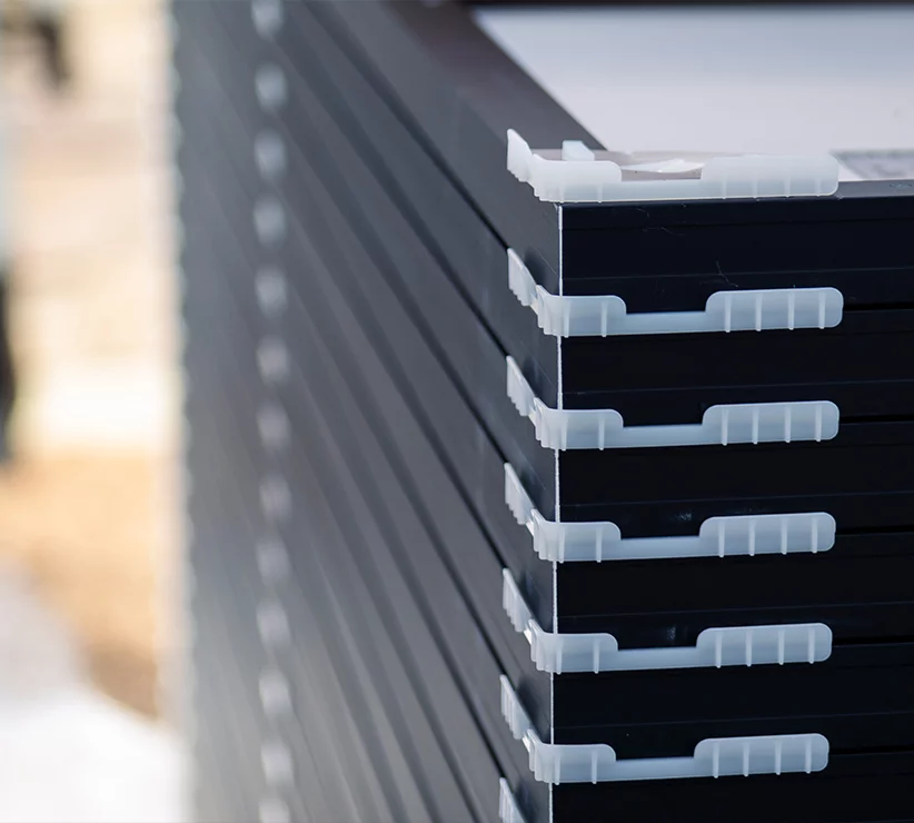 Solar panels stacked on top of each other with plastic separators between each