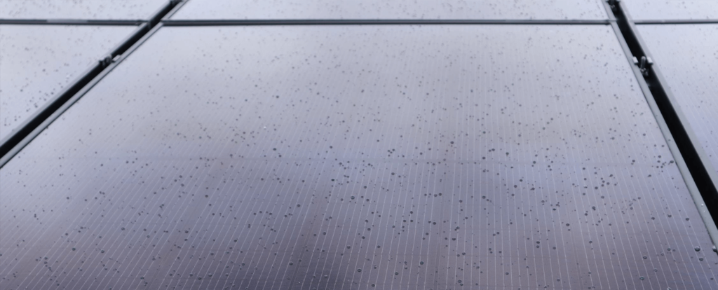Up close view of six solar panel system with rain drops on the surface
