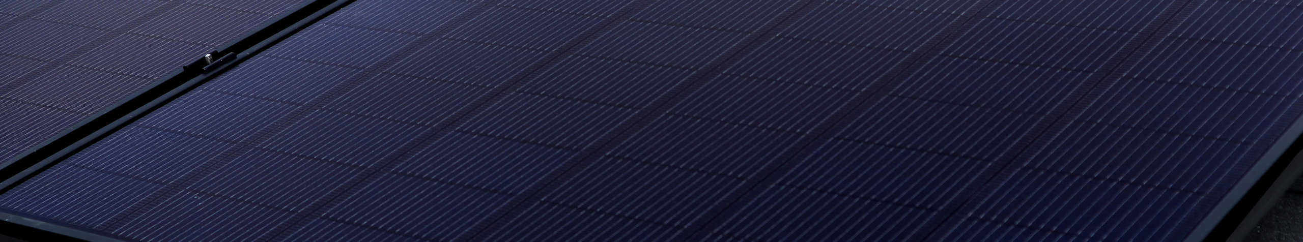 Zoomed in view of solar panel installed on roof, focusing on individual solar cells