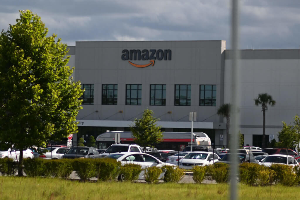 Amazon warehouse with cars parked in front