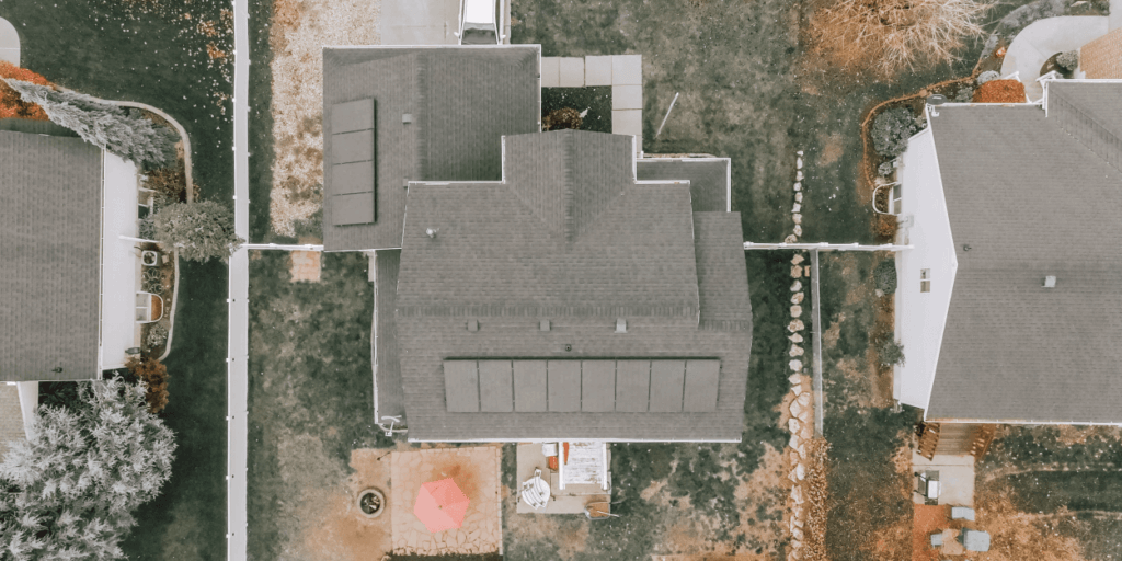 Bird's eye view of a home with a row of PV solar panels installed