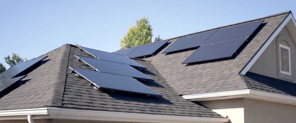 Multiple solar arrays on a light brown shingle home