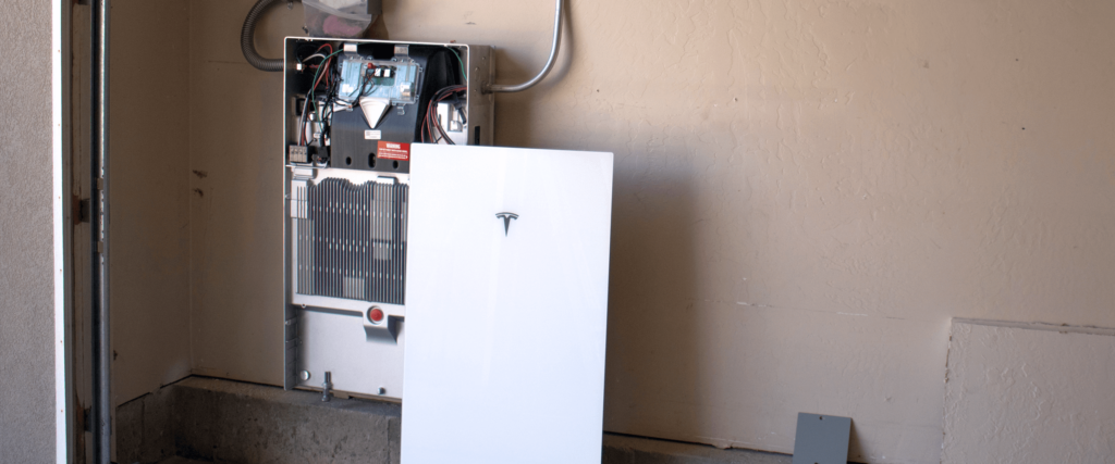 Tesla Powerwall 3 cover and inside of a batter getting installed in a garage