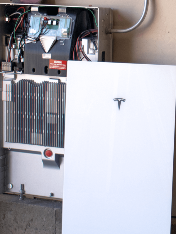 Tesla Powerwall 3 cover and inside of a batter getting installed in a garage