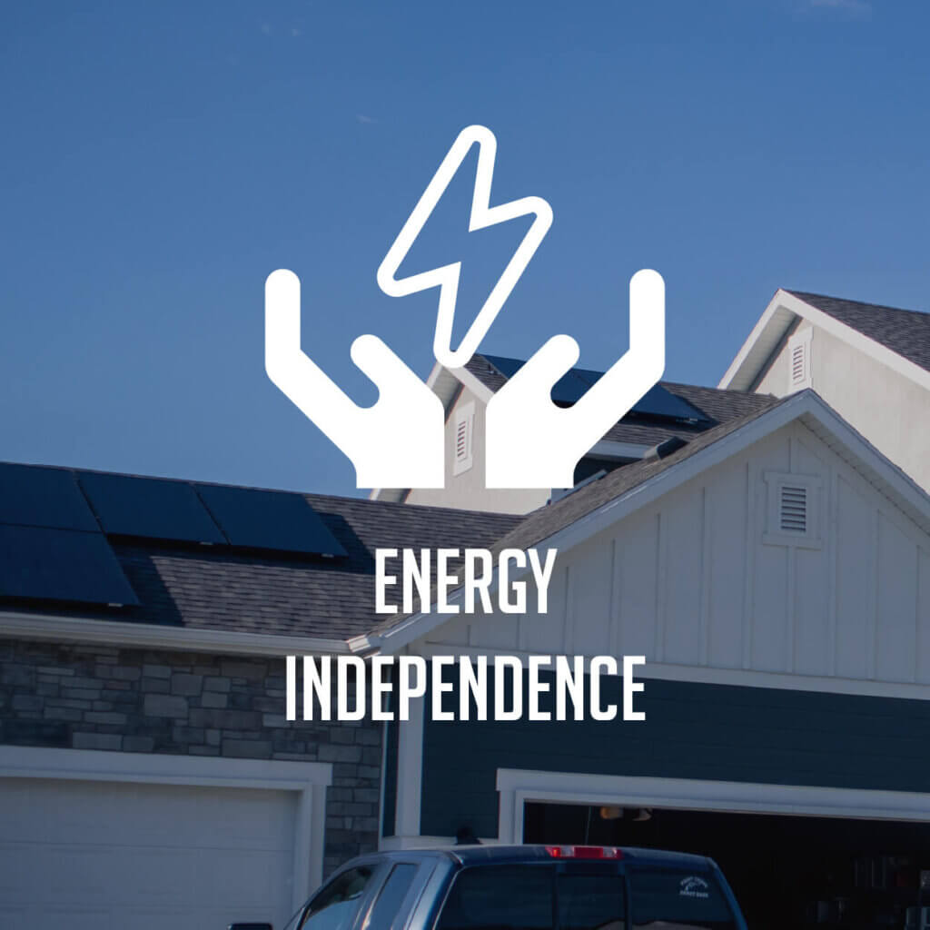 'Energy Independence' text overlaid on a two-car garage house with PV panels installed