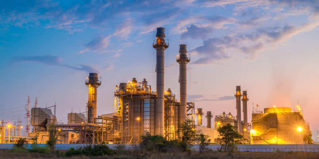 Understanding the Grid_A Comprehensive Guide_02 Traditional power plant with wispy clouds and bright lights