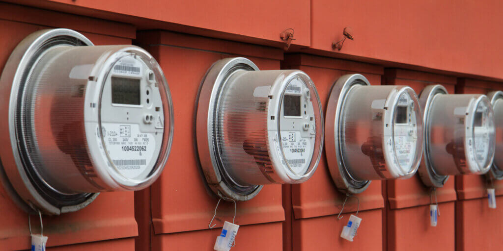 Understanding the Grid_A Comprehensive Guide_03 Power meters installed next to each other with orange background